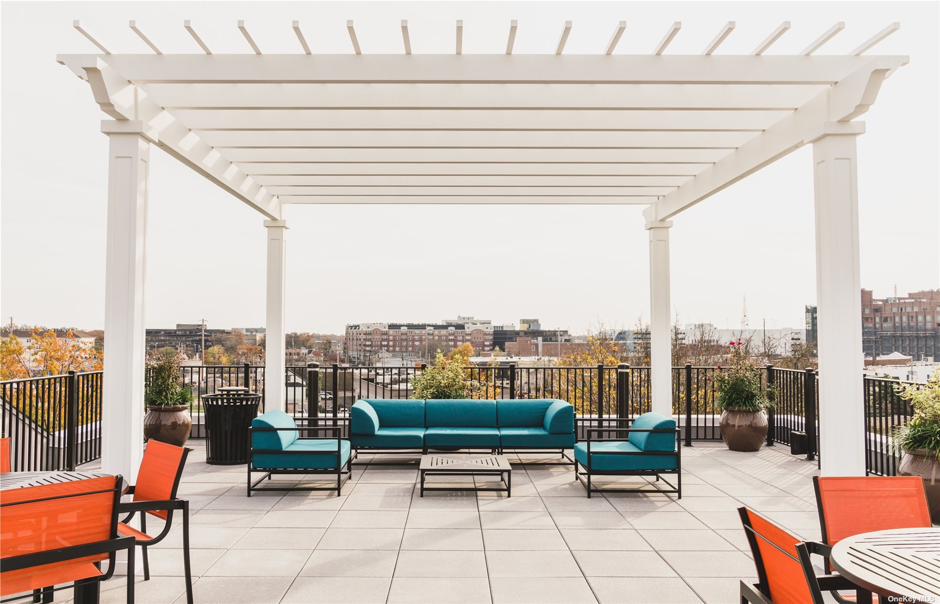 a roof deck with outdoor seating and city view
