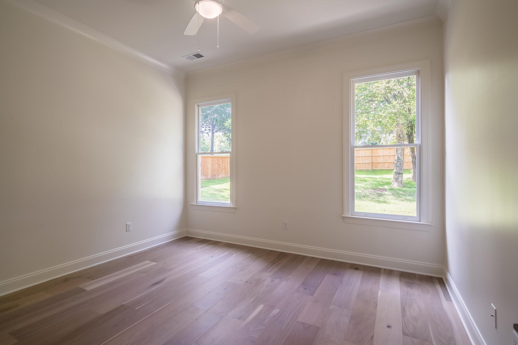 4099 Barfield Road Memphis, TN 38117 - Photo 13 of 25 a view of an empty room with wooden floor and a window