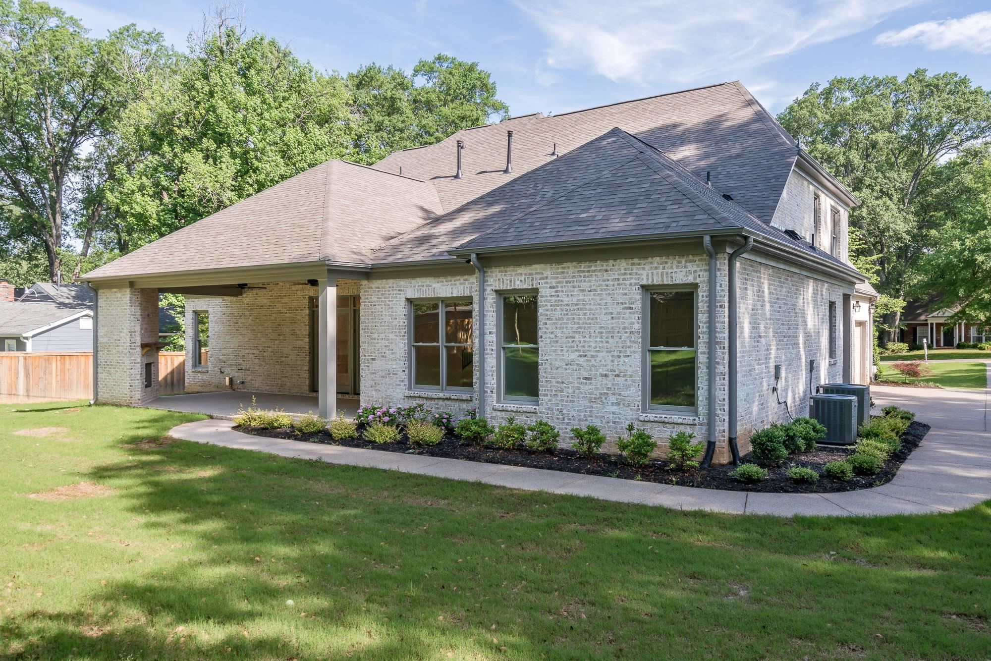 4099 Barfield Road Memphis, TN 38117 - Photo 21 of 25 a front view of a house with a garden and plants