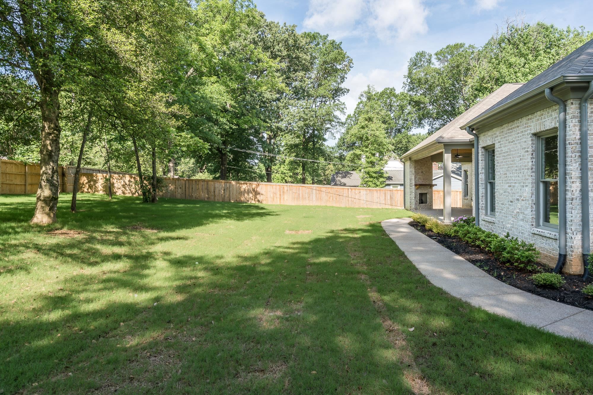 4099 Barfield Road Memphis, TN 38117 - Photo 24 of 25 a view of a house with a big yard potted plants and large tree