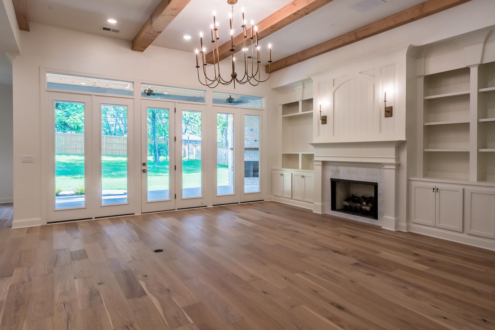4099 Barfield Road Memphis, TN 38117 - Photo 5 of 25 a view of an empty room with wooden floor fireplace and a window