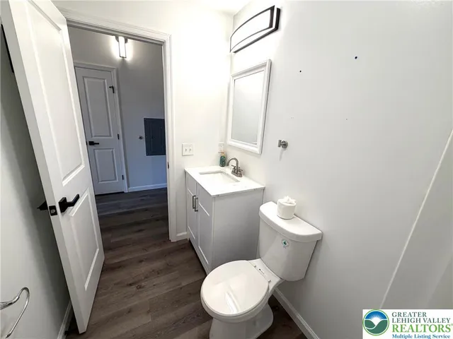 a bathroom with a sink a toilet a mirror and vanity