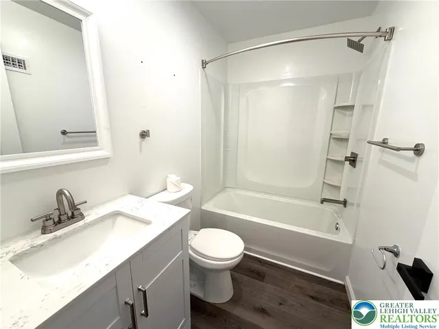 a bathroom with a sink a toilet and a bathtub