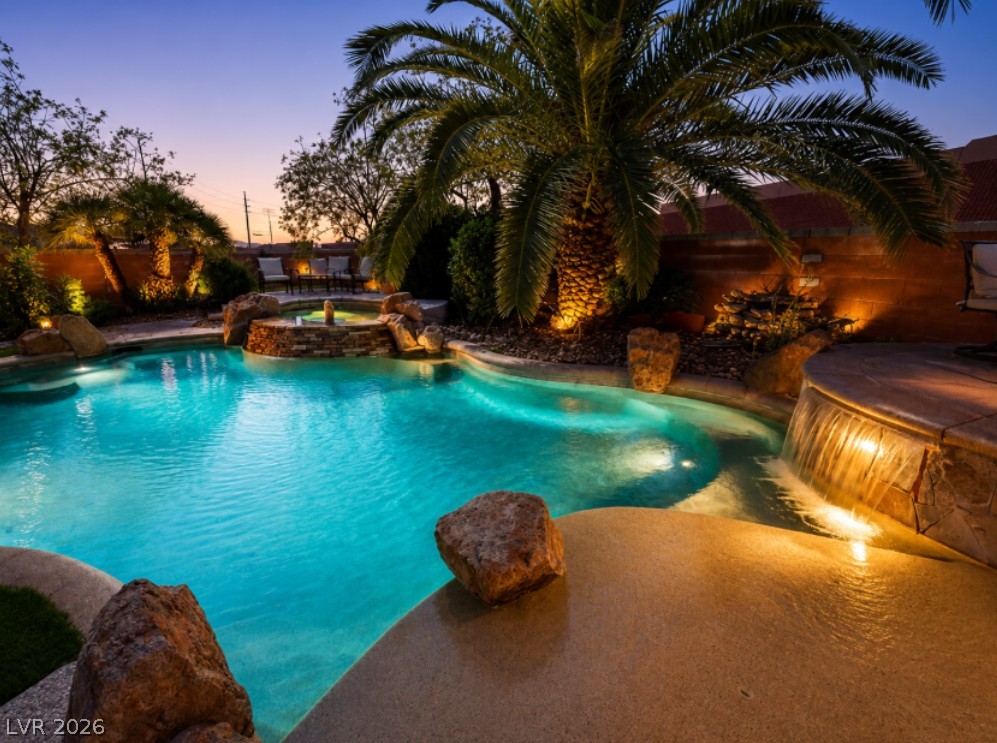 6405 North Raptor Court North Las Vegas, NV 89084 - Photo 1 of 66 A tranquil oasis awaits, complete with a sparkling pool, integrated spa, and illuminated landscaping.