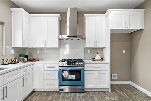 a kitchen with white cabinets and white appliances