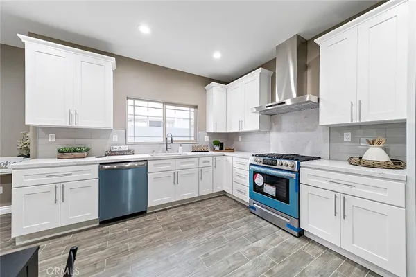 a kitchen with granite countertop white cabinets and white appliances