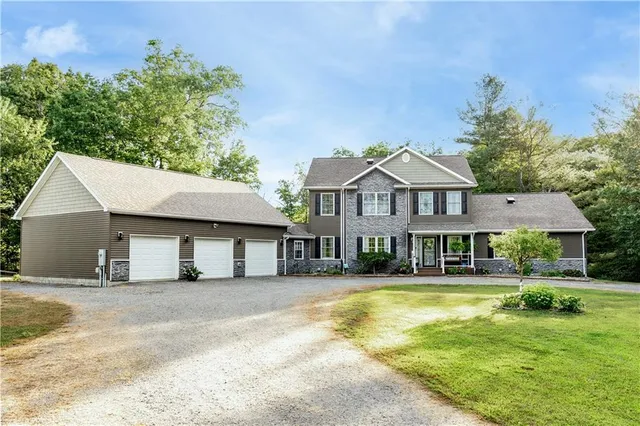 a front view of a house with a yard table and chairs