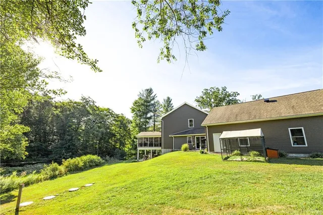 a front view of house with yard and trees