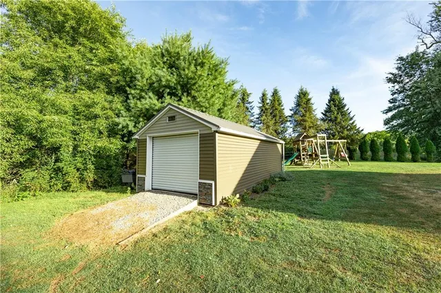 a view of a house with yard and a garden