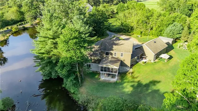 an aerial view of a house with a yard basket ball court and outdoor seating