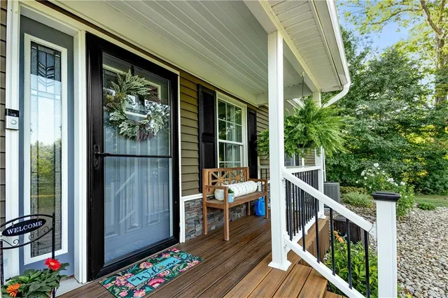 a balcony with wooden floor table and chairs