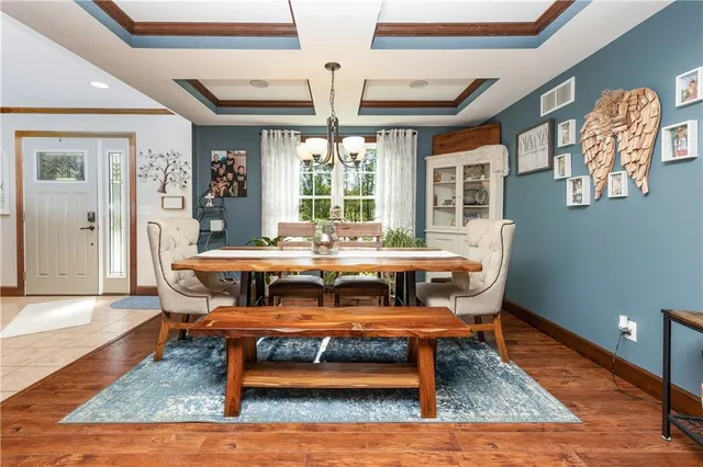 a reading room with furniture rug and wooden floor