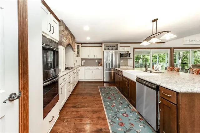 a kitchen with a sink and a stove top oven