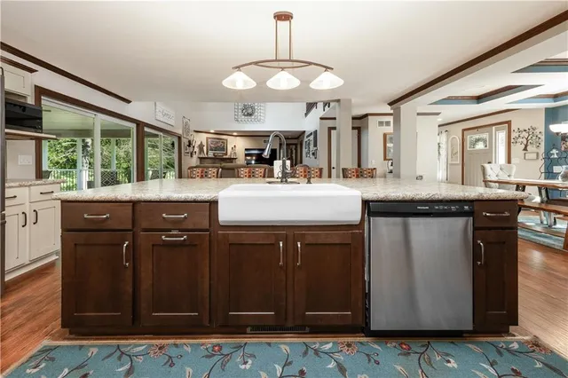 a kitchen with granite countertop a table chairs stove and kitchen view