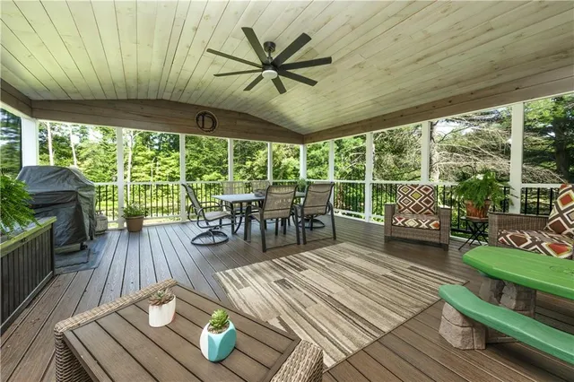 a spacious bedroom with a bed and a ceiling fan