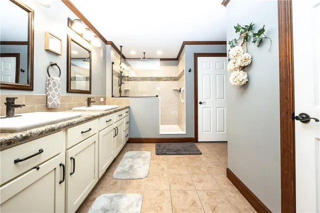 a bathroom with a sink vanity and mirror