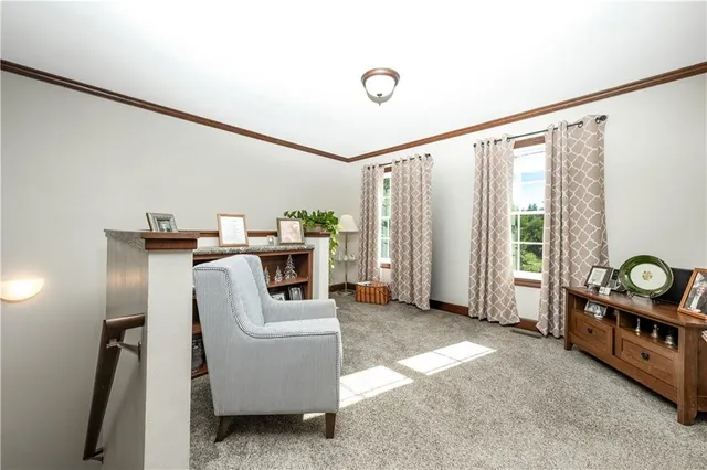 a bedroom with a bed and a flat tv screen on dresser