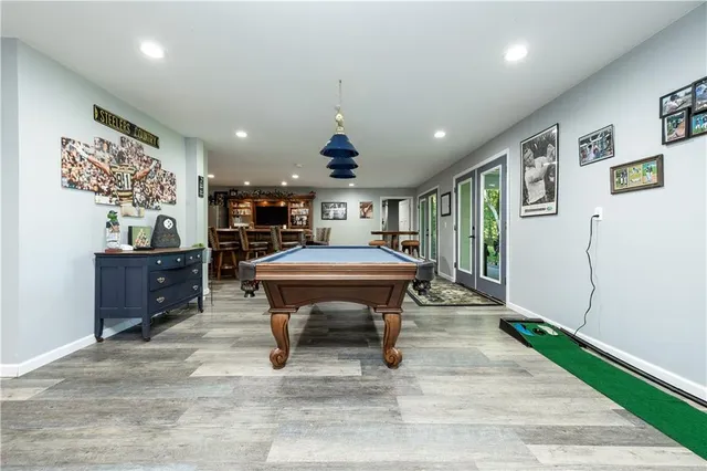 a living room with furniture a table and chairs next to a large window