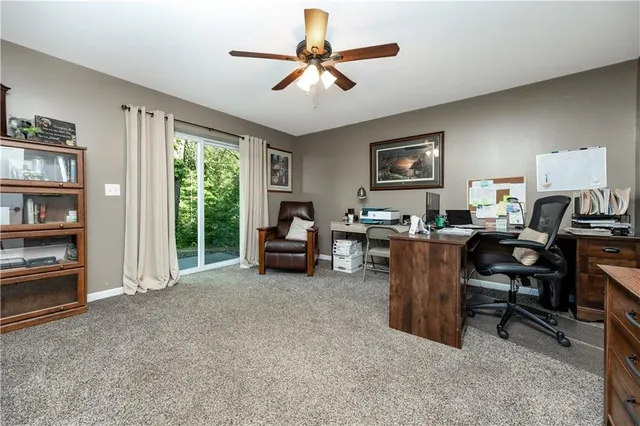 a room with gym equipment and wooden floor