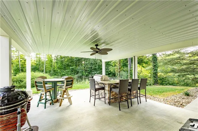 a view of a patio with a table chairs and backyard