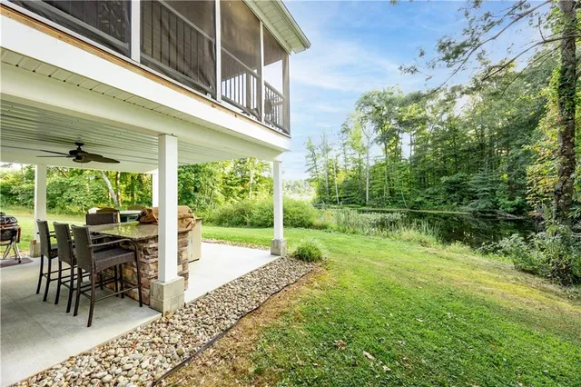 a view of a porch with chairs and backyard