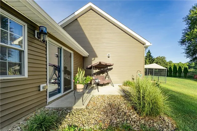 a view of a backyard with plants and a patio