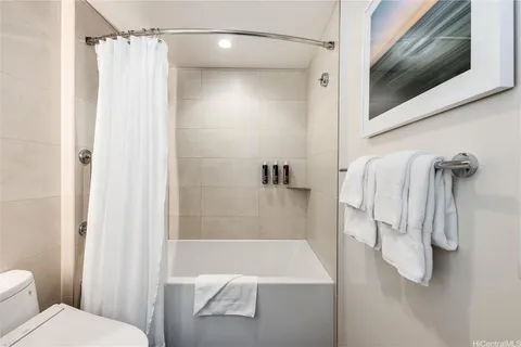 a bathroom with a shower and a toilet