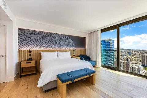 a bedroom with a large bed and a large window