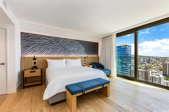 a bedroom with a large bed and a large window