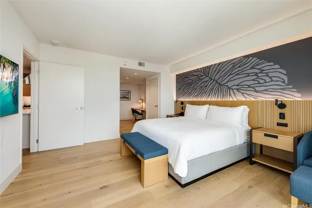 a bedroom with a bed and a night stand