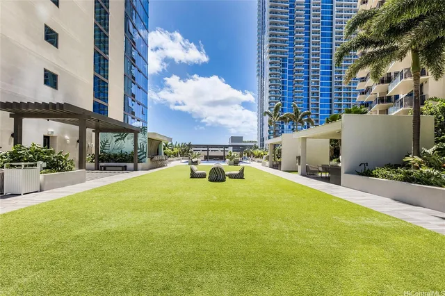 a swimming pool with outdoor seating and yard