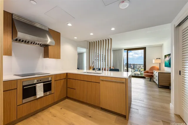 a kitchen with stainless steel appliances granite countertop a stove and a sink