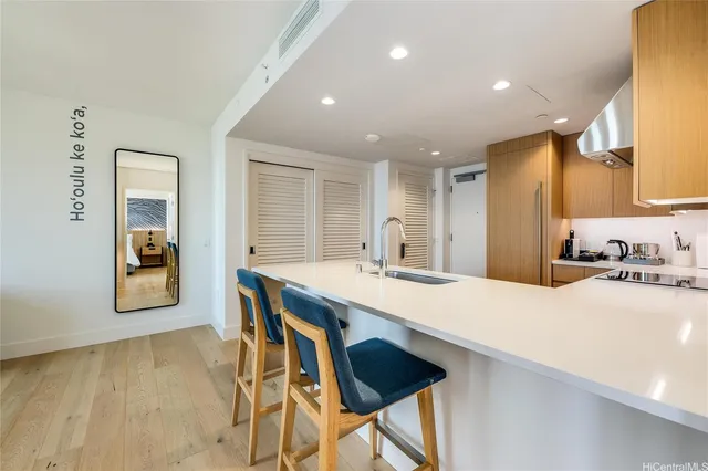 a large kitchen with kitchen island a sink table and chairs