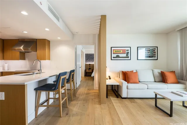 a living room with furniture and a wooden floor