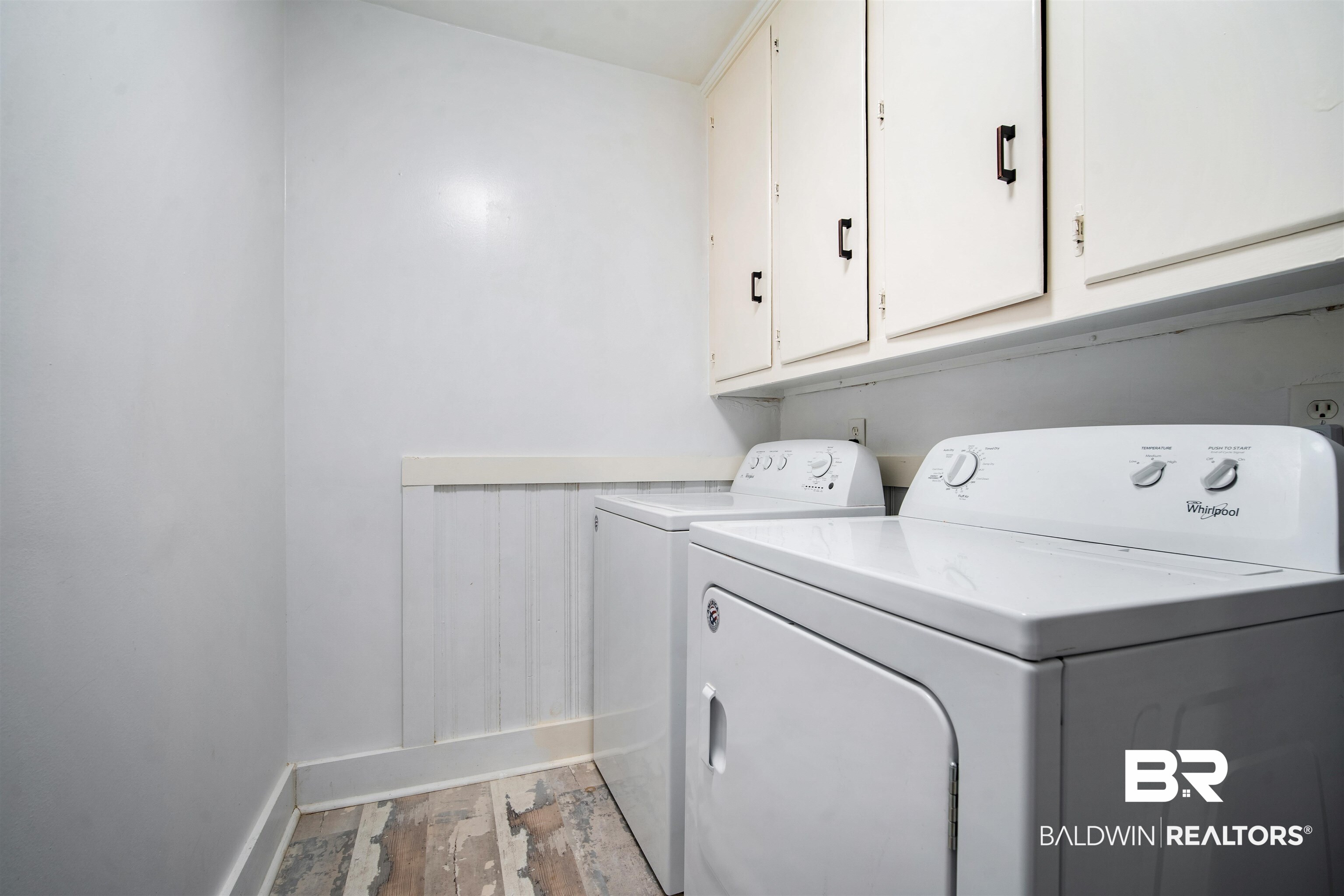 2615 Walton Avenue Mobile, AL 36606 - Photo 28 of 33 Laundry area with light wood-style flooring, independent washer and dryer, cabinet space, and baseboards