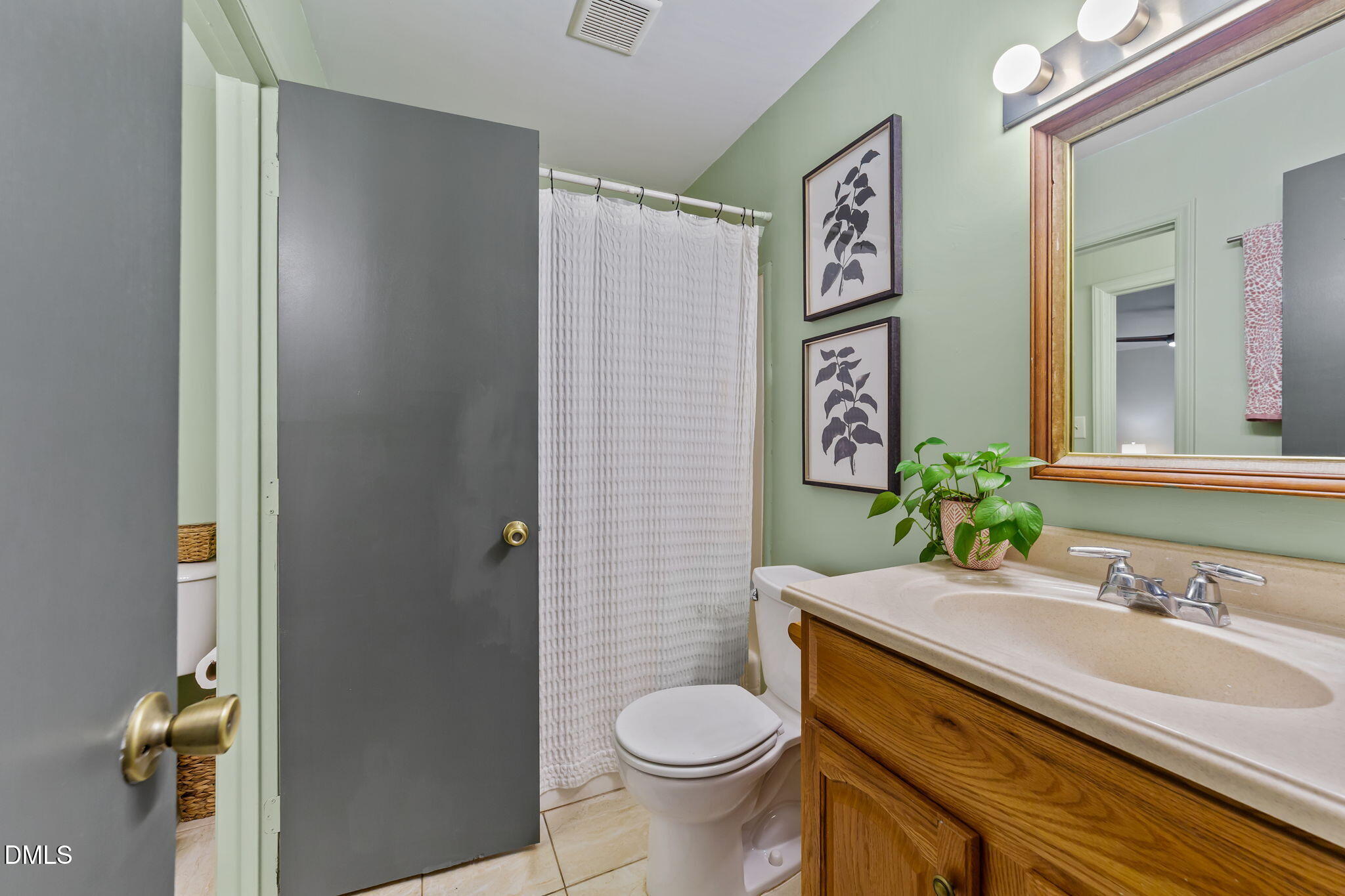 105 Barcliff Terrace Cary, NC 27518 - Photo 21 of 47 a bathroom with a granite countertop toilet a sink and a mirror