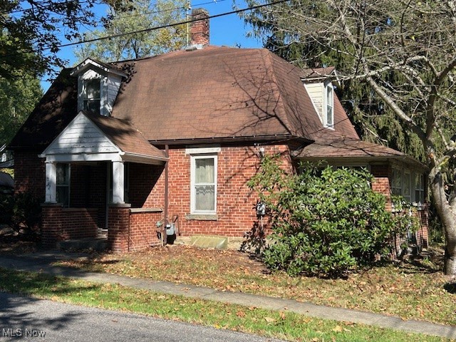 6128 Riverview Road Peninsula, OH 44264 - Photo 4 of 17 View of front of property with a chimney, brick siding, and a shingled roof