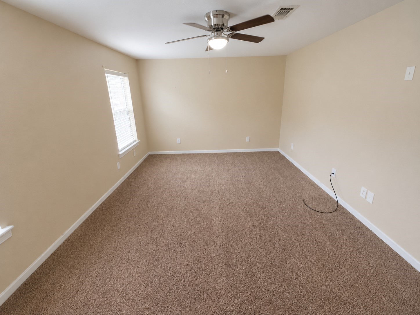 12926 Abalone Way Houston, TX 77044 - Photo 10 of 15 an empty room with windows and fan