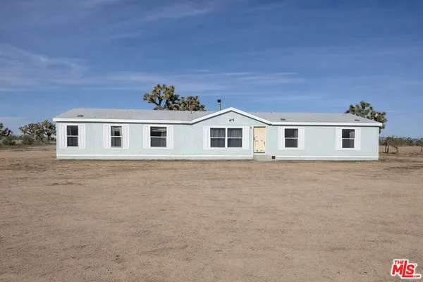a house view with a backyard space