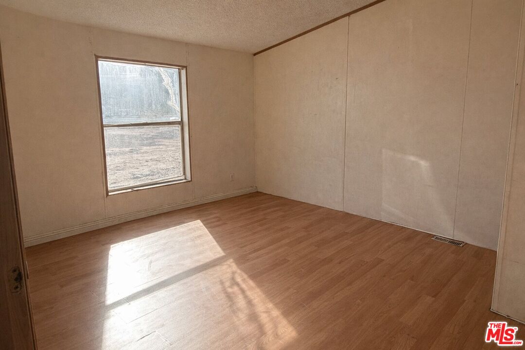 6288 Maricopa Road Phelan, CA 92371 - Photo 12 of 17 an empty room with windows