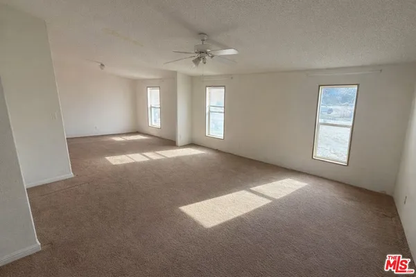a bathroom with a granite countertop sink a mirror and a bathtub