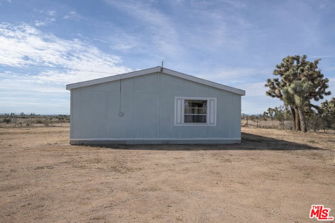 6288 Maricopa Road Phelan, CA 92371 - Photo 4 of 17 a house with trees in front of it