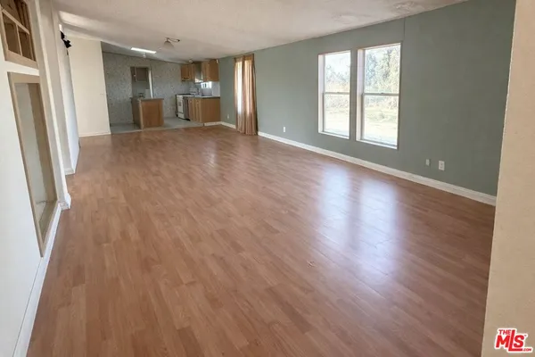 a bathroom with a granite countertop sink toilet a mirror and shower