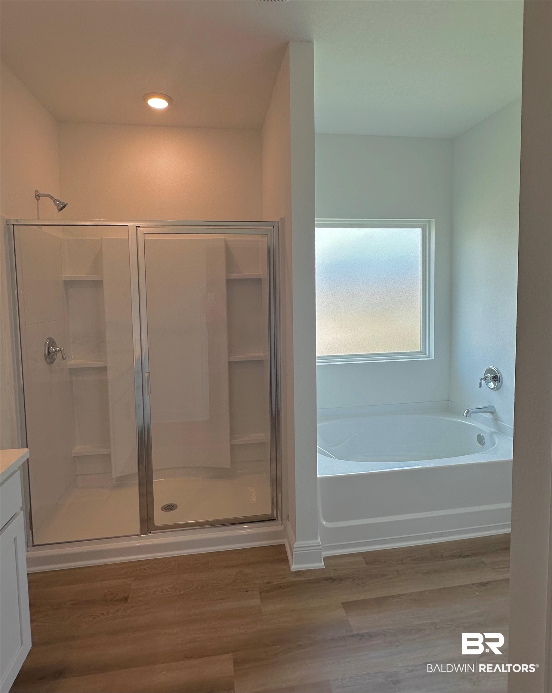 12905 Grand Rpds Road Fairhope, AL 36532 - Photo 12 of 29 Bathroom with shower with separate bathtub, hardwood / wood-style flooring, and vanity