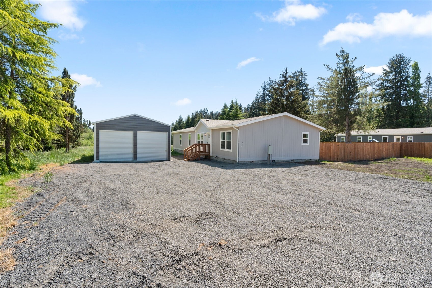 1090 Koontz Road Chehalis, WA 98532 - Photo 28 of 35 a front view of a house with a yard and garage