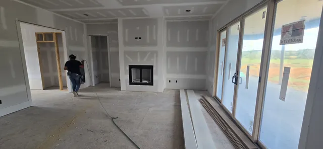 a view of a hallway with fireplace and a fireplace