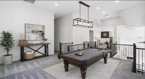 a living room with furniture a rug and a chandelier