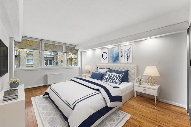 a bedroom with a bed and wooden floor