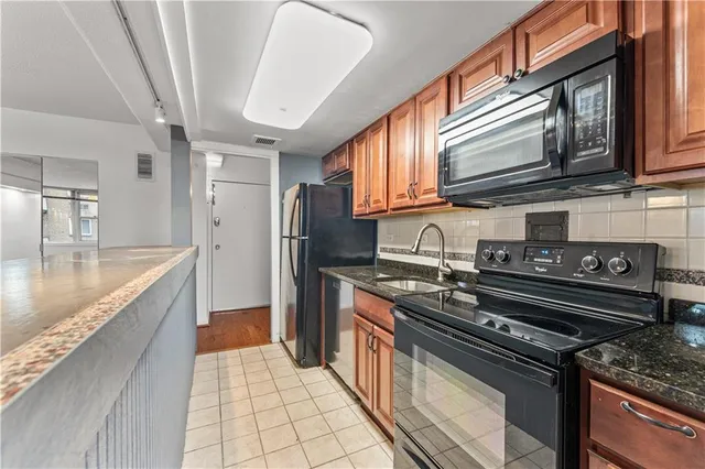 a kitchen with stainless steel appliances granite countertop a stove and a sink