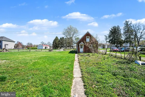 a view of a house with a yard and sitting area